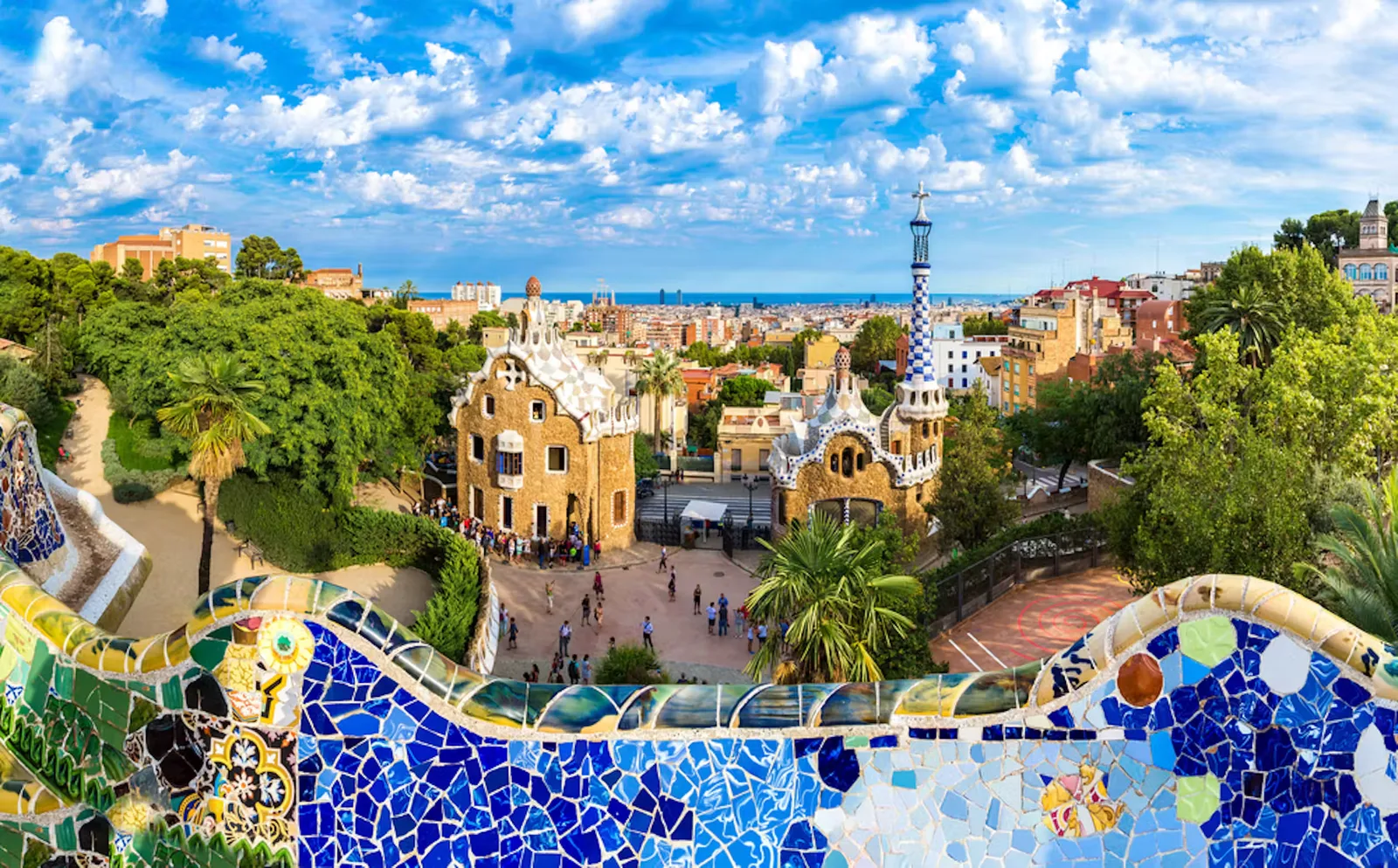 Park Güell’s mosaic terrace overlooking its entrance pavilions and Barcelona